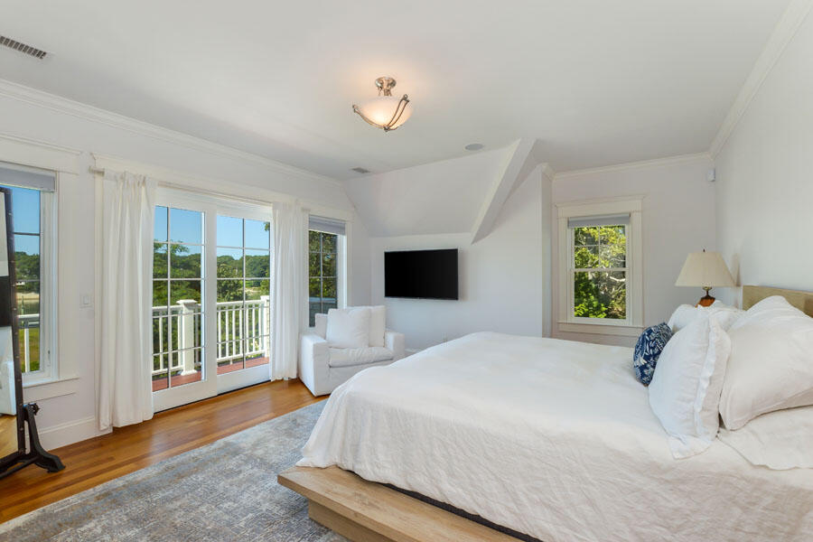 501 Eel River Road Osterville, MA 02655 - Photo 26 of 50 a bedroom with a large bed and a large window