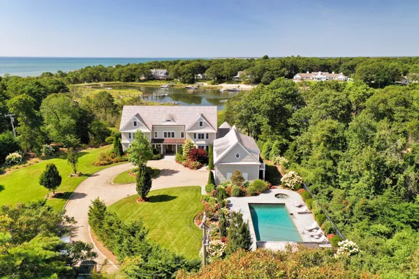 an aerial view of a house with yard swimming pool and outdoor seating