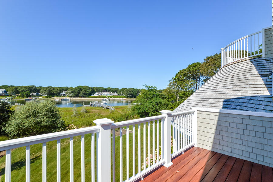 501 Eel River Road Osterville, MA 02655 - Photo 32 of 50 a view of a wooden deck with a lake