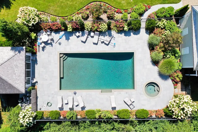 an aerial view of a house with garden space and a street view
