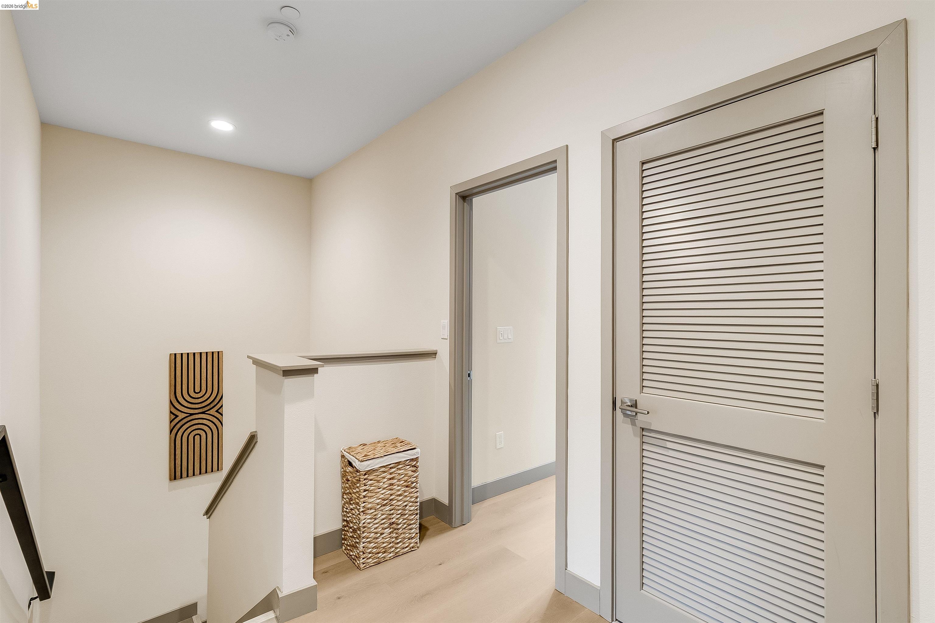 1357 Pullman Way Oakland, CA 94607 - Photo 20 of 37 Upper landing with light wood-finish flooring, recessed lighting, and a contemporary louvered door