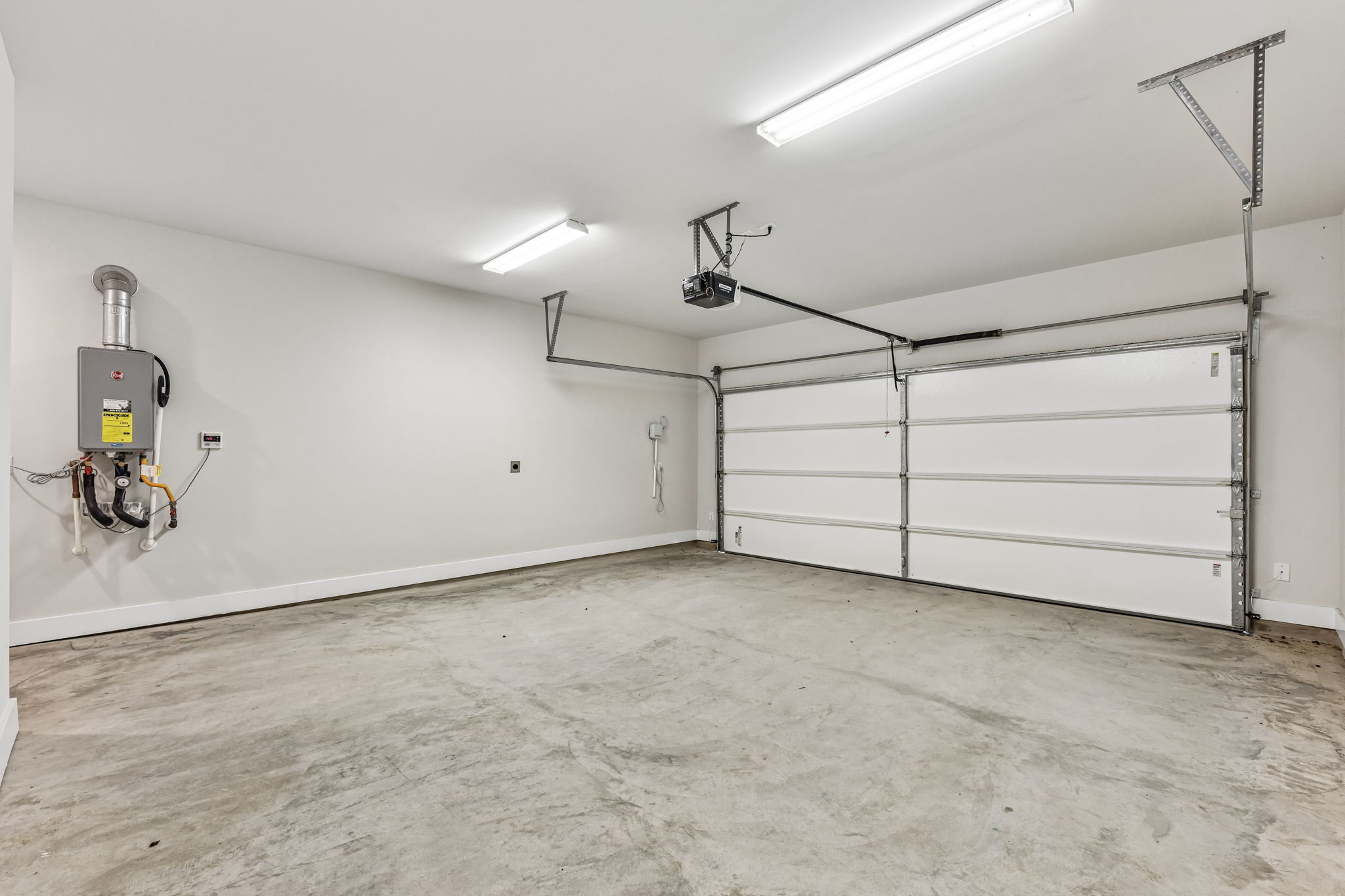 9101 Cattle Baron Path Austin, TX 78747 - Photo 33 of 40 A spacious, pristine garage features an automatic door opener and a convenient tankless water heater.
