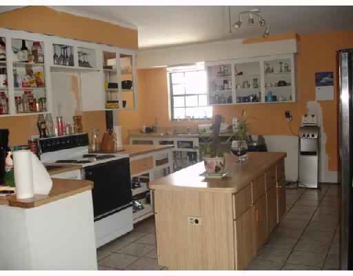 1533 Southeast Pitcher Road Port St. Lucie, FL 34952 - Photo 3 of 7 a kitchen with a sink stove and refrigerator