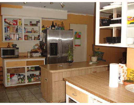 1533 Southeast Pitcher Road Port St. Lucie, FL 34952 - Photo 5 of 7 a kitchen with stainless steel appliances granite countertop a sink and a refrigerator