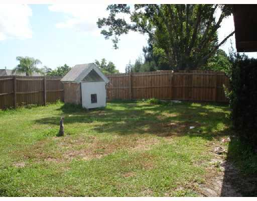 1533 Southeast Pitcher Road Port St. Lucie, FL 34952 - Photo 6 of 7 a garden covered with wooden fence