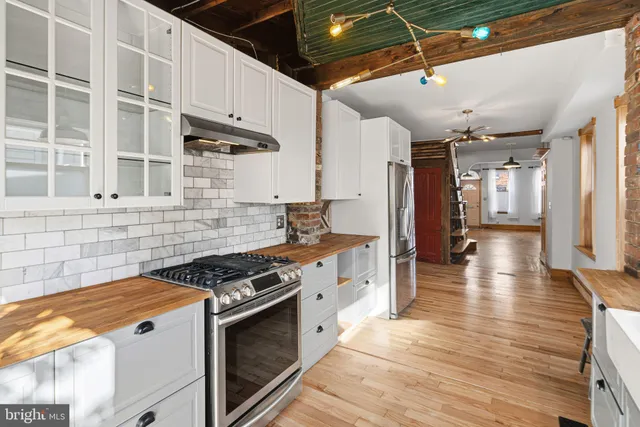 a kitchen with stainless steel appliances granite countertop a stove and a refrigerator