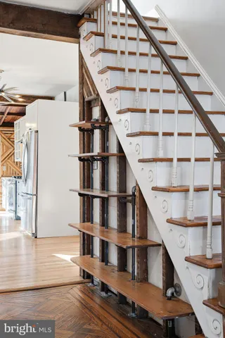 a view of entryway with wooden floor and stairs