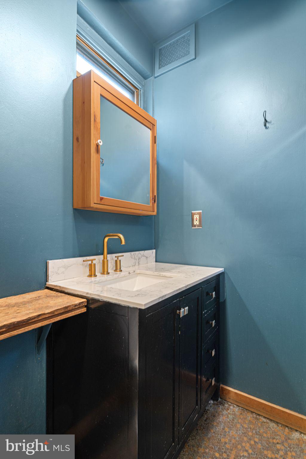 2142 East Huntingdon Street Philadelphia, PA 19125 - Photo 26 of 37 a bathroom with a sink vanity and a mirror