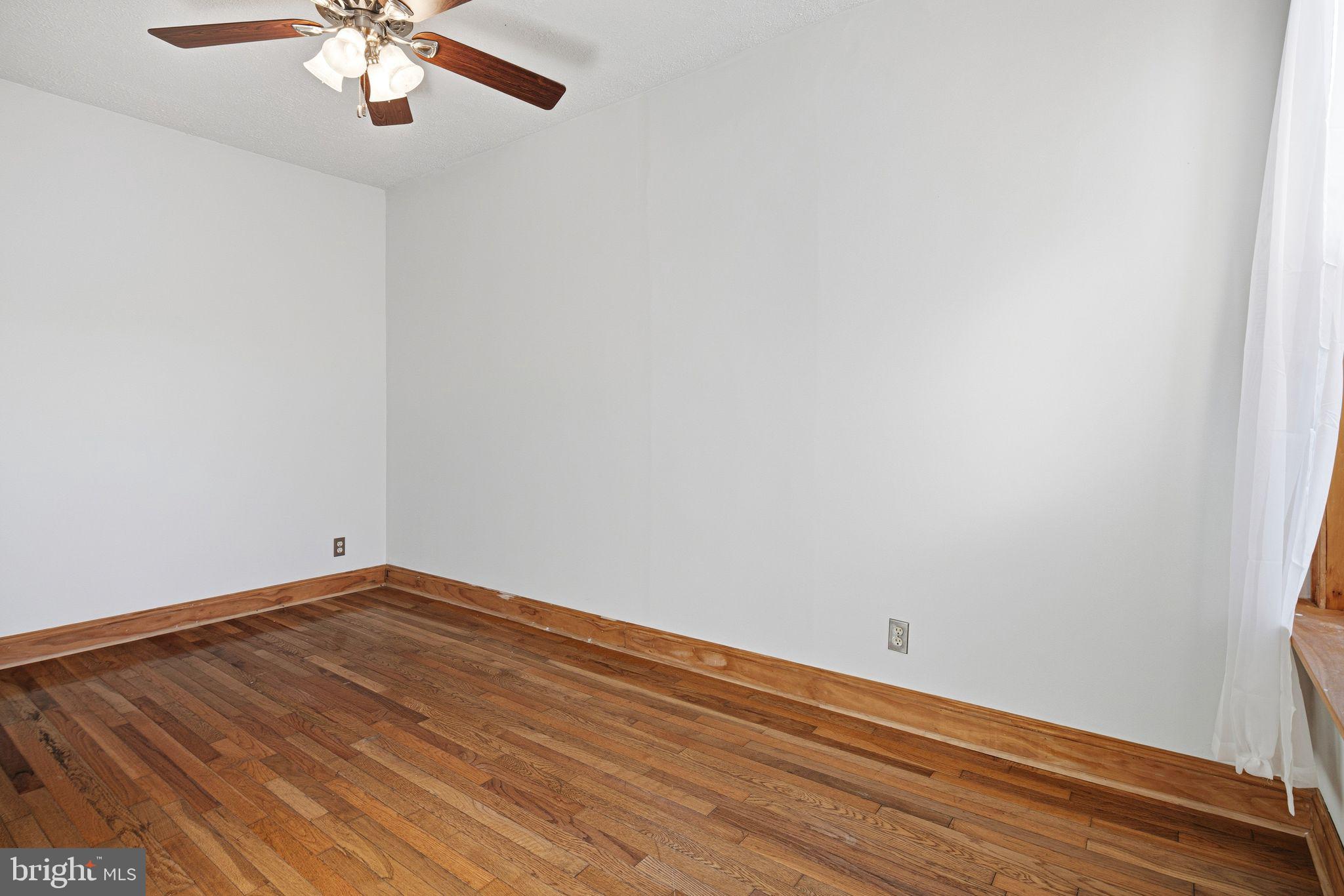 2142 East Huntingdon Street Philadelphia, PA 19125 - Photo 26 of 38 a view of a room with wooden floor and a ceiling fan