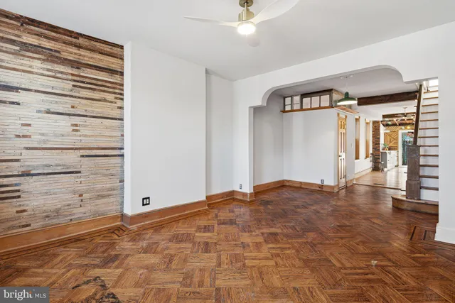 a view of empty room with wooden floor