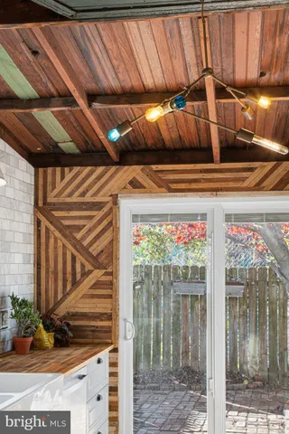 a view of a backyard door with wooden floor