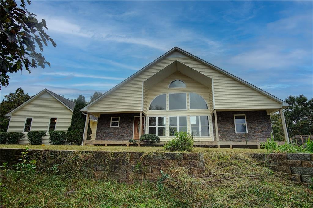 a front view of a house with garden