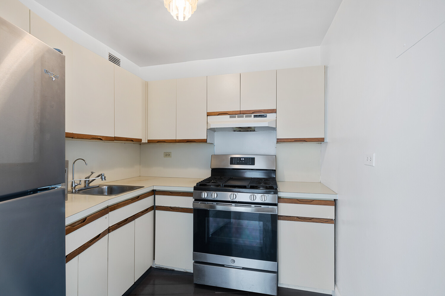 1020 Grand Concourse, Unit 20B Bronx, NY 10451 - Photo 7 of 10 a kitchen with stainless steel appliances a stove and white cabinets