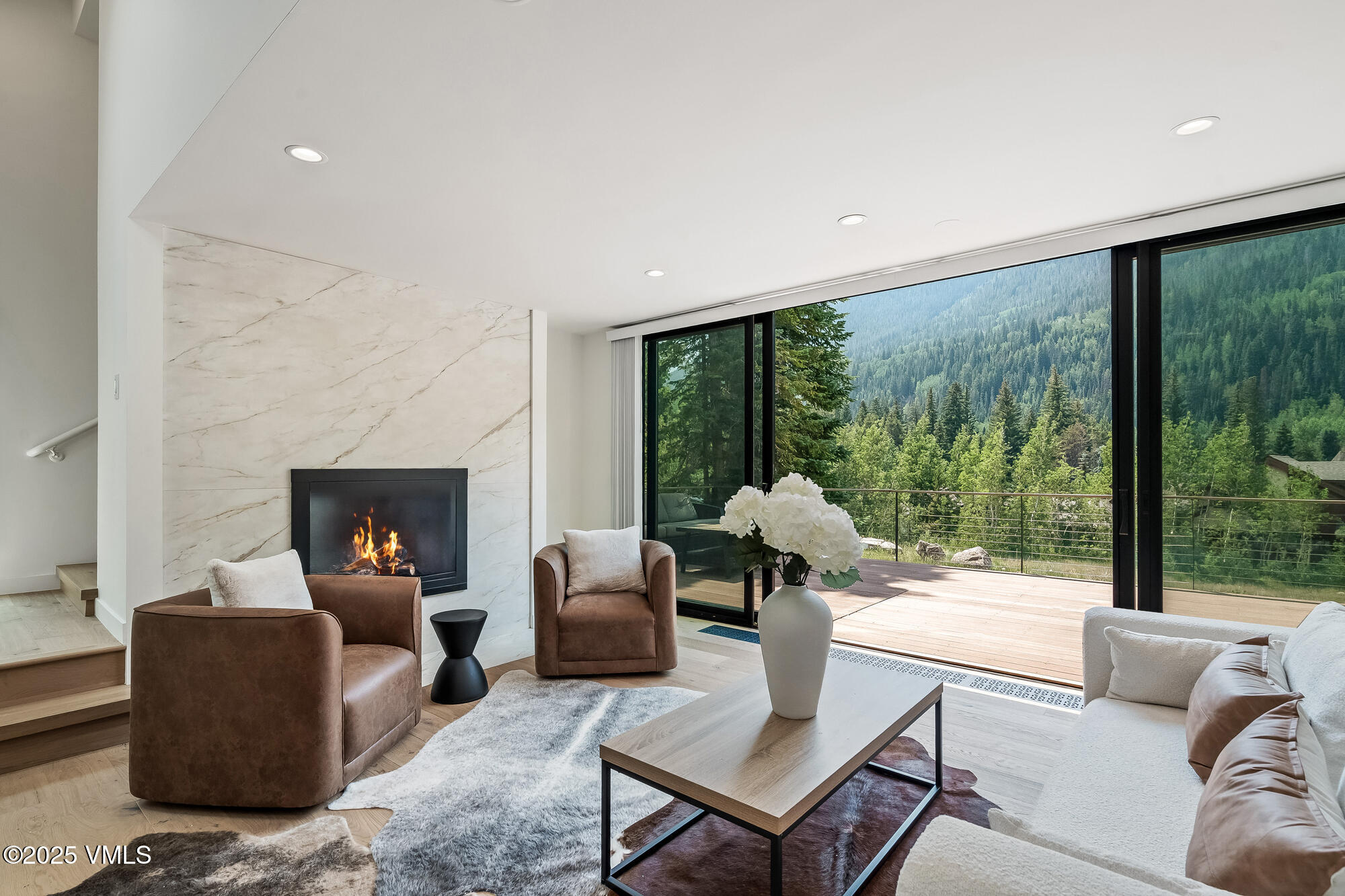4545 Big Horn Road Vail, CO 81657 - Photo 2 of 49 a living room with furniture and a fireplace