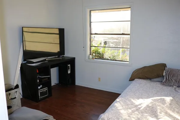a bedroom with a bed and window