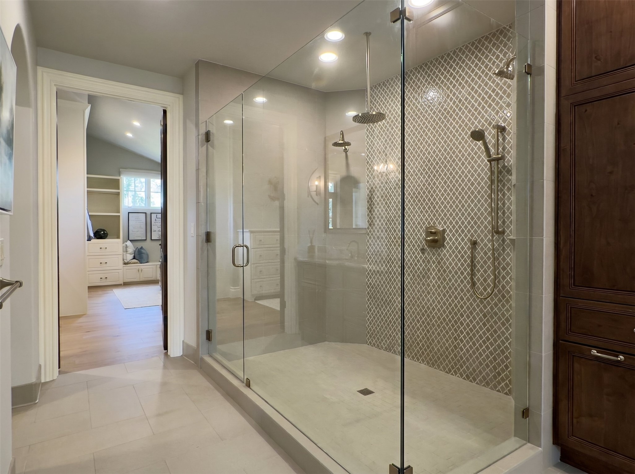 433 Brandon Way Austin, TX 78733 - Photo 19 of 40 Luxurious walk-in shower with dual shower heads and sleek glass enclosure.