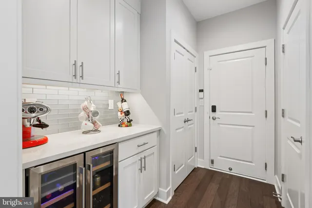 a view of a storage and utility room with wooden floor