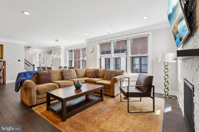 a living room with furniture a fireplace and a flat screen tv