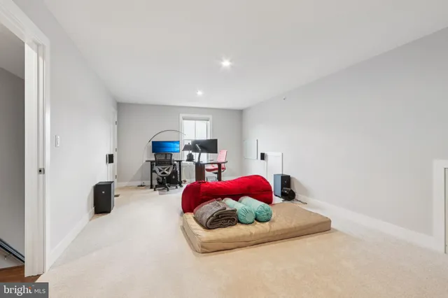 a living room with furniture and gym equipment
