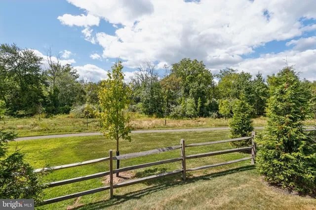 a view of a yard with wooden fence