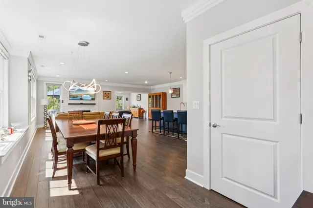 a dining area with furniture and wooden floor