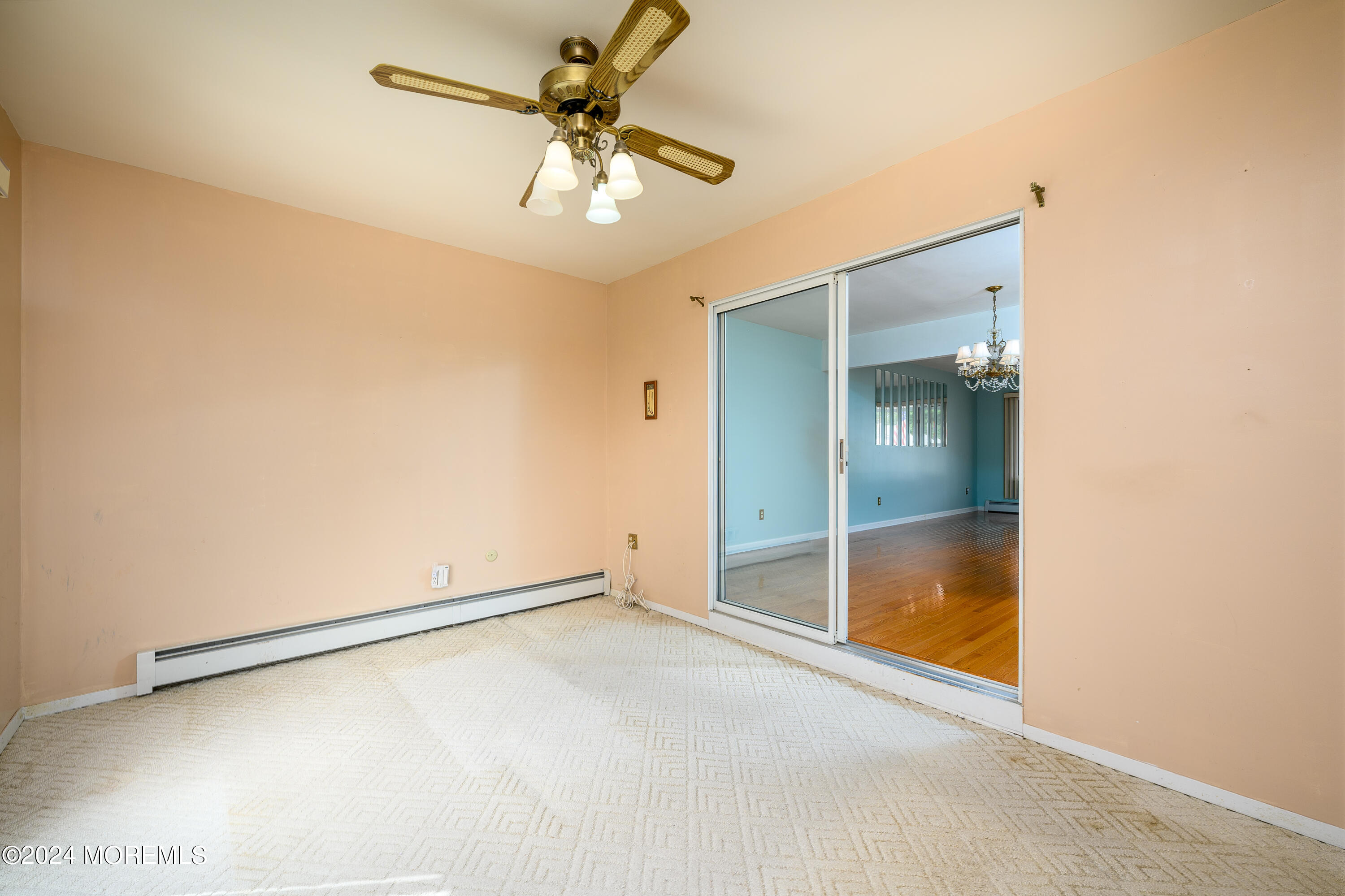 56 Auburn Road Toms River, NJ 08757 - Photo 18 of 28 an empty room with a ceiling fan and carpet