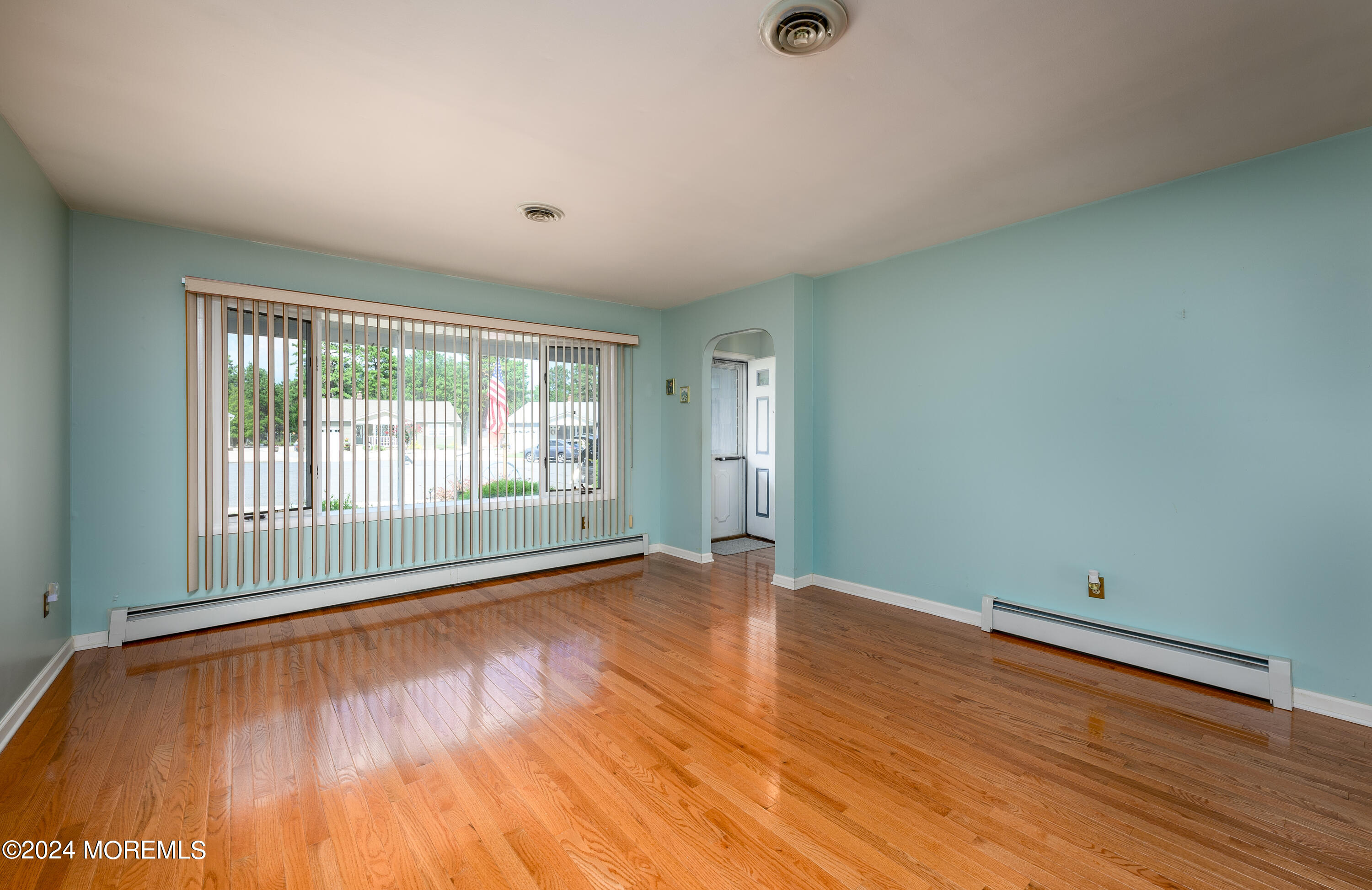 56 Auburn Road Toms River, NJ 08757 - Photo 5 of 28 a view of an empty room with wooden floor and a window