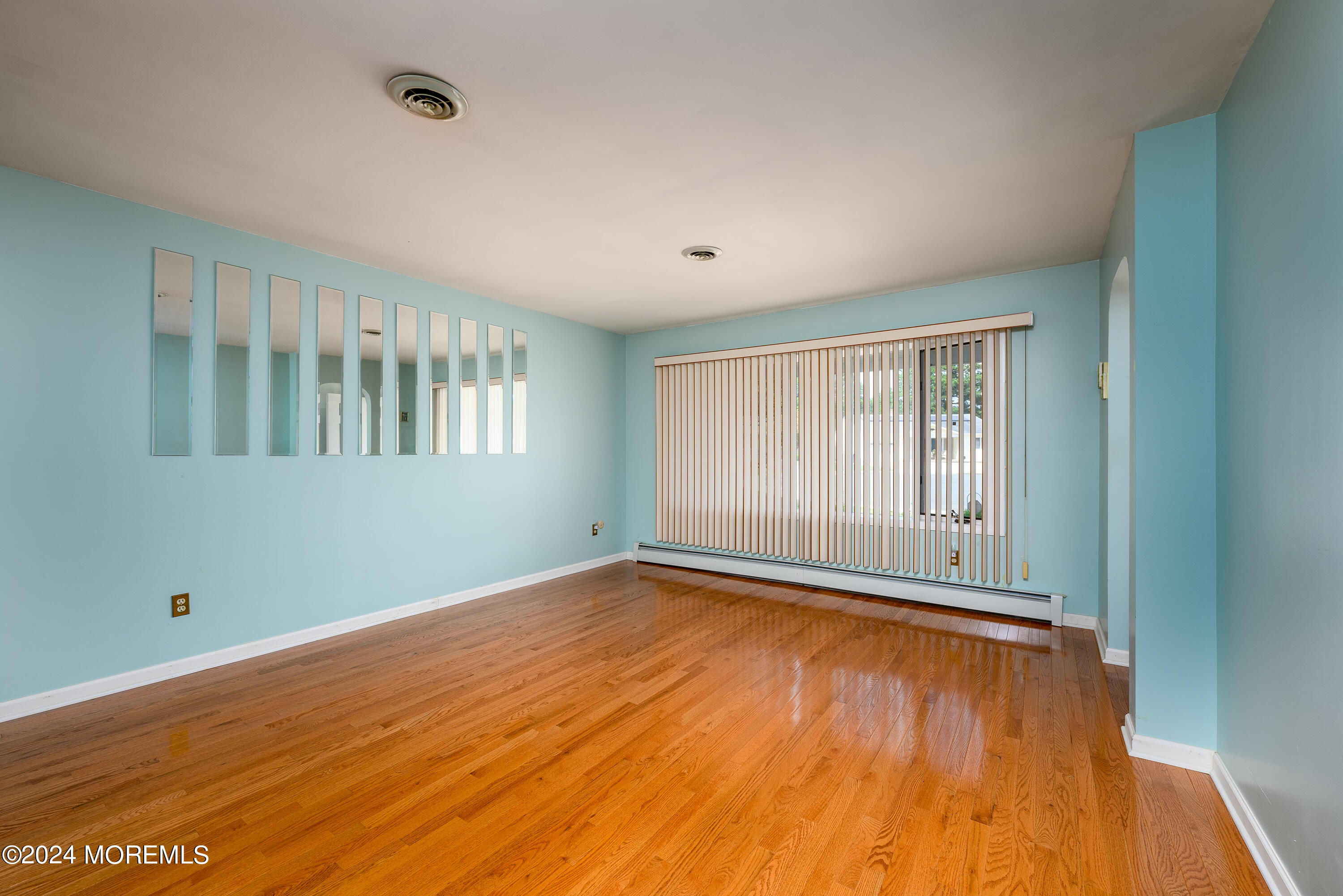 56 Auburn Road Toms River, NJ 08757 - Photo 6 of 28 a view of an empty room with wooden floor and a window