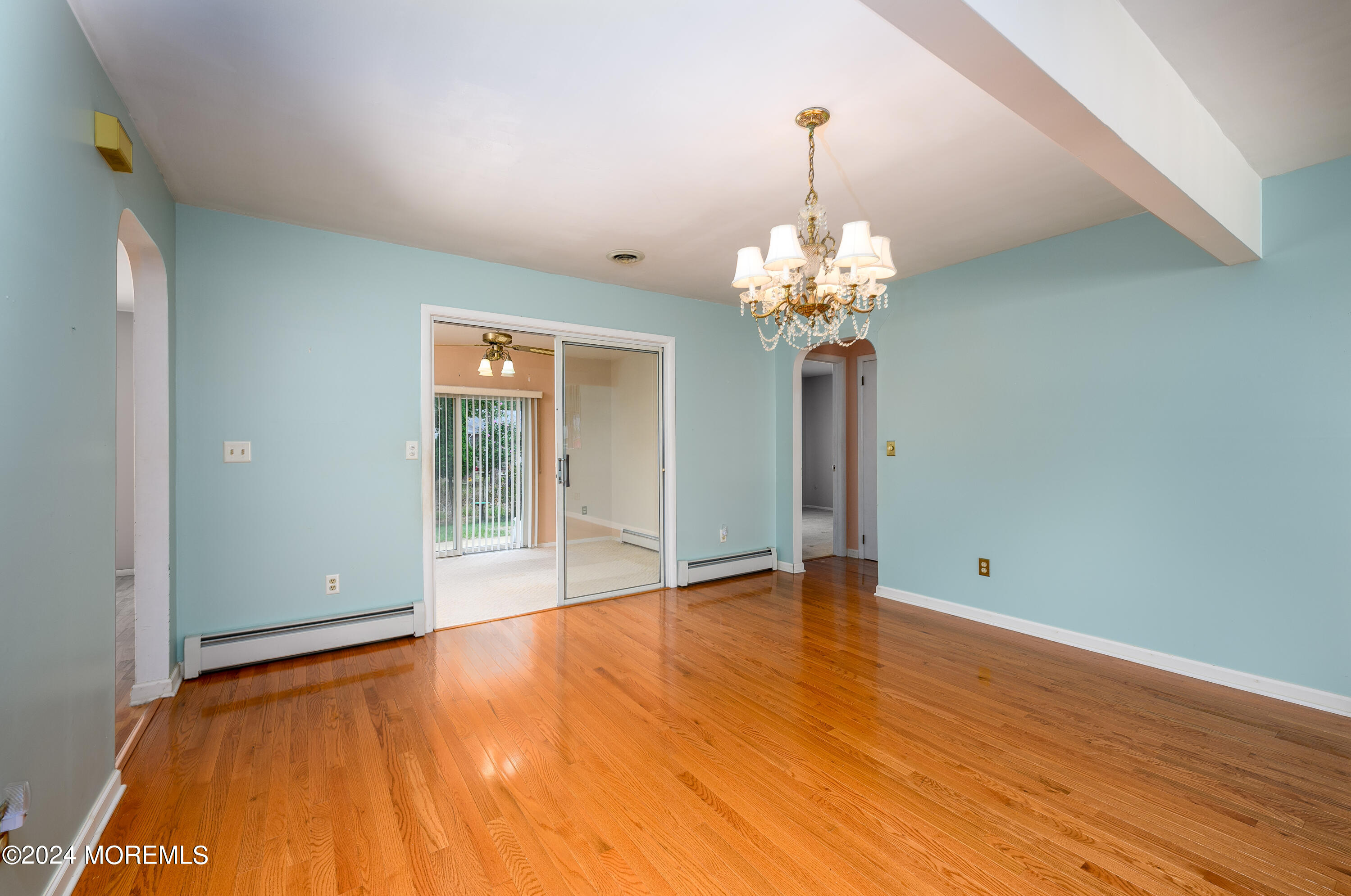 56 Auburn Road Toms River, NJ 08757 - Photo 8 of 28 a view of an empty room with chandelier and wooden floor