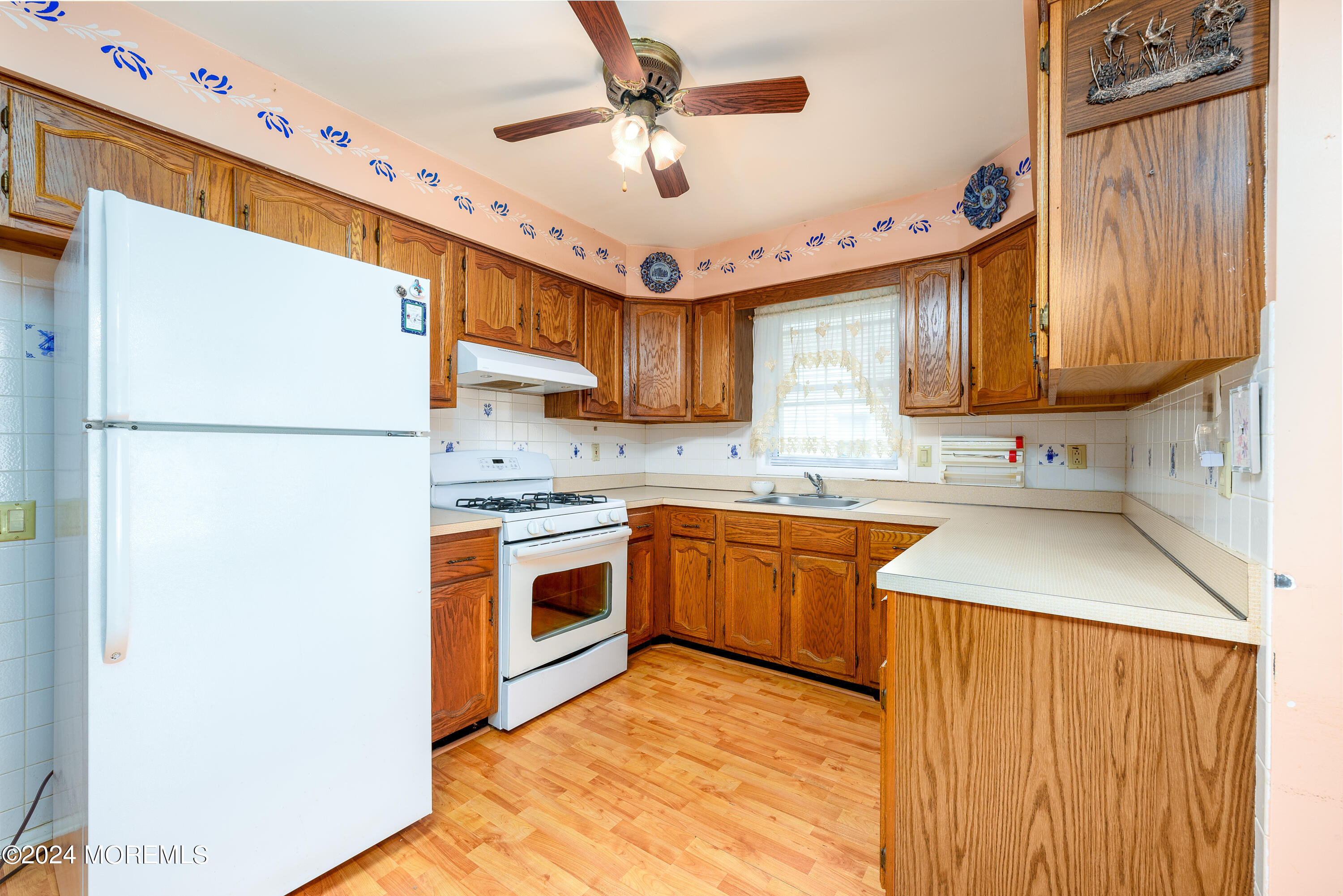 56 Auburn Road Toms River, NJ 08757 - Photo 10 of 28 a kitchen with stainless steel appliances granite countertop a refrigerator a sink dishwasher a stove with wooden cabinets