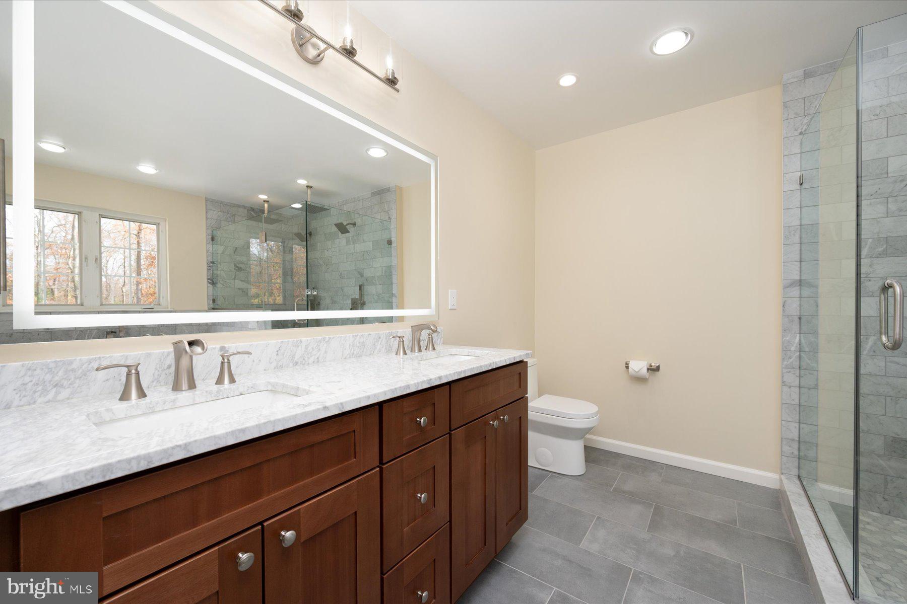 2942 Southaven Drive Annapolis, MD 21401 - Photo 17 of 41 a bathroom with a double vanity sink and a mirror