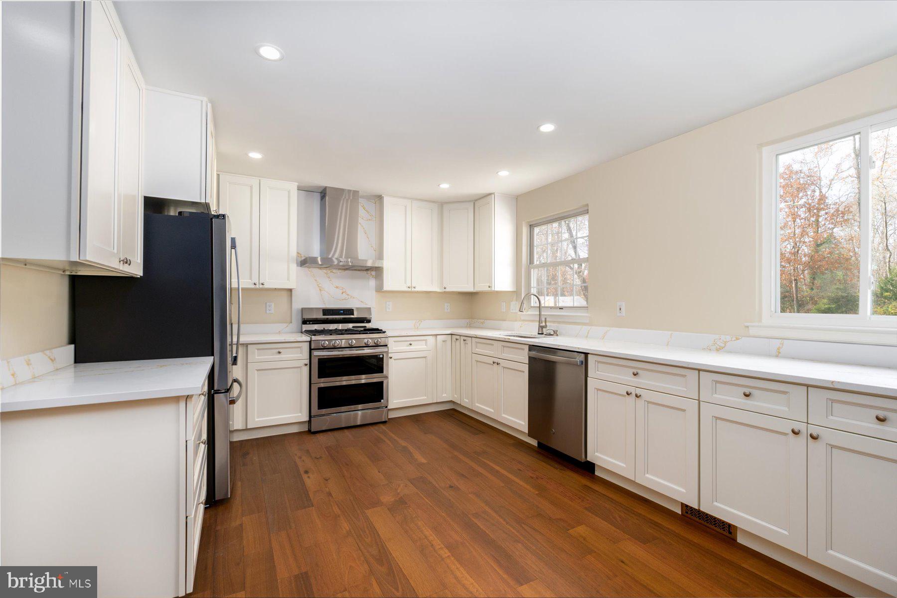 2942 Southaven Drive Annapolis, MD 21401 - Photo 3 of 41 a kitchen with granite countertop white cabinets and stainless steel appliances