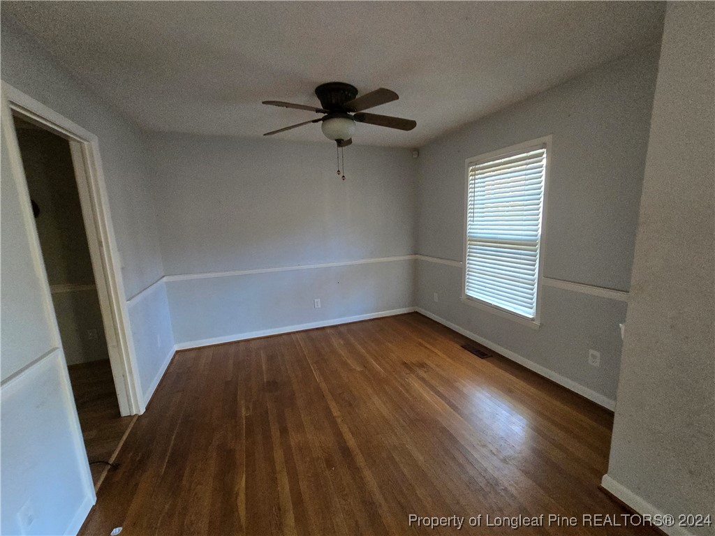 6400 Milford Road Fayetteville, NC 28303 - Photo 13 of 23 a view of an empty room with wooden floor and a window