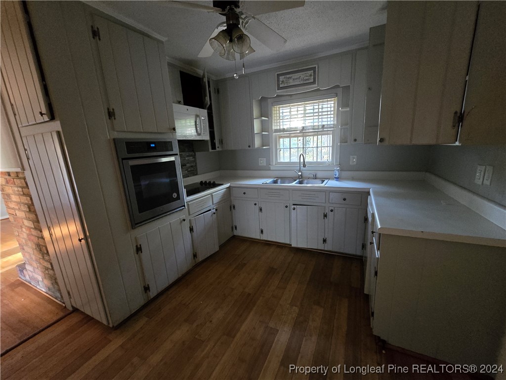 6400 Milford Road Fayetteville, NC 28303 - Photo 16 of 23 a kitchen with granite countertop a sink stainless steel appliances and cabinets