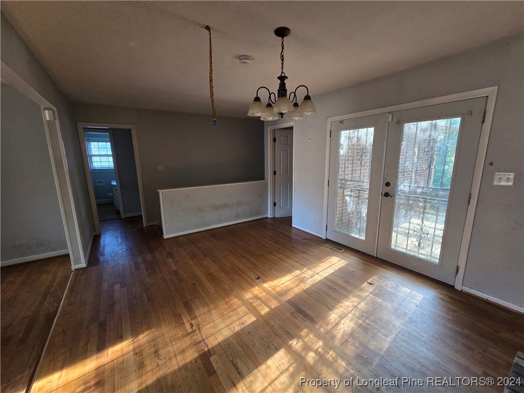 6400 Milford Road Fayetteville, NC 28303 - Photo 17 of 23 a view of an empty room with window and wooden floor