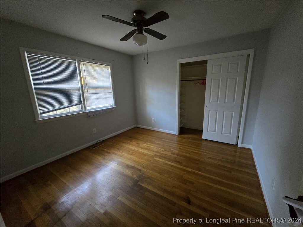6400 Milford Road Fayetteville, NC 28303 - Photo 18 of 23 a view of an empty room with wooden floor and a window