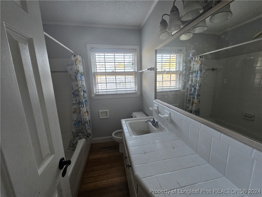 6400 Milford Road Fayetteville, NC 28303 - Photo 19 of 23 a bathroom with a tub sink and shower