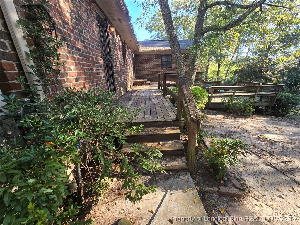 6400 Milford Road Fayetteville, NC 28303 - Photo 6 of 23 a view of backyard with table and chairs and potted plants