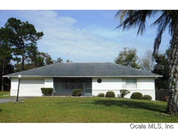 8247 Southwest 103rd Street Road Ocala, FL 34481 - Photo 1 of 1 a front view of a house with a garden