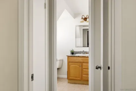 a en suite bathroom with a granite countertop sink and a mirror
