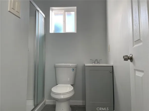a bathroom with a toilet sink and vanity