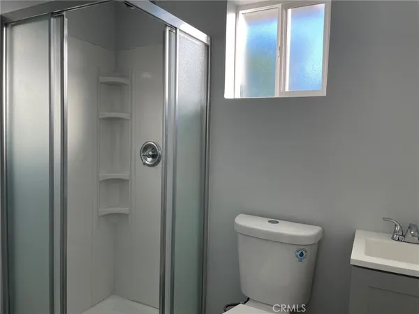 a bathroom with a toilet and a shower