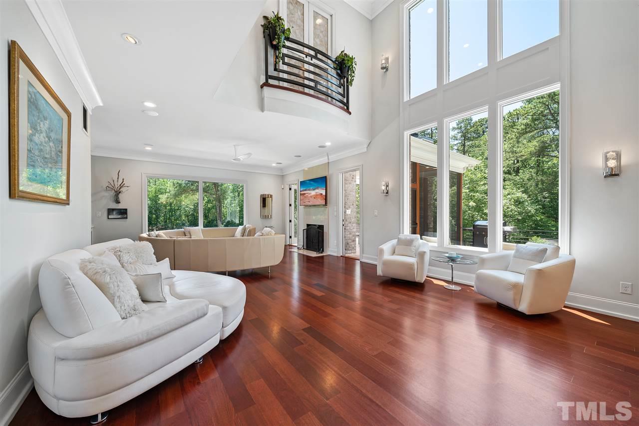 1209 Graedon Drive Raleigh, NC 27603 - Photo 11 of 30 Two storied windows, LED lights, Brazilian hardwoods, Juliette balcony looking down from the Master Suite. Picture lighting to highlight artwork.