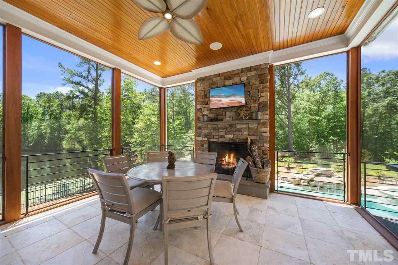1209 Graedon Drive Raleigh, NC 27603 - Photo 13 of 30 Wood burning fireplace with gas lighter. Views of pool waterfall and jacuzzi.