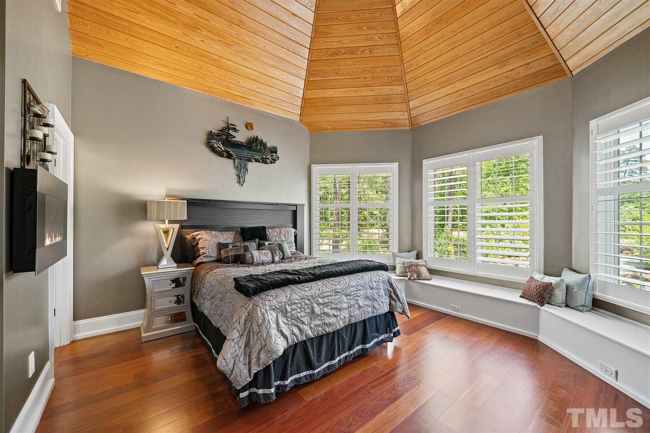1209 Graedon Drive Raleigh, NC 27603 - Photo 22 of 30 20ft+ high wood paneled ceiling. Bench window seating open for storage. Walk-in spa shower and plantation shutters.