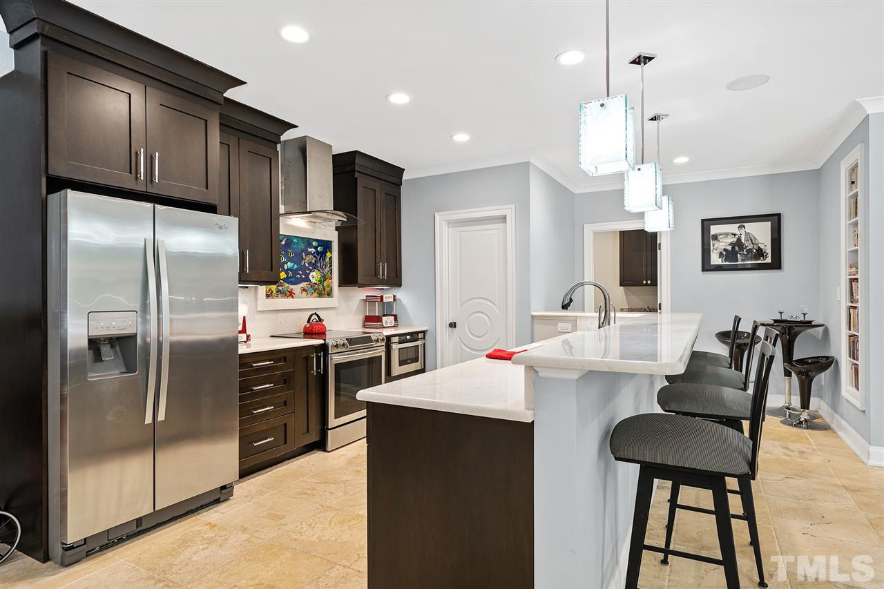 1209 Graedon Drive Raleigh, NC 27603 - Photo 23 of 30 Ocean themed LED backlit mural, freestanding icemaker for parties, hidden spice racks, pull out microwave, quartz & marble exotic stone.