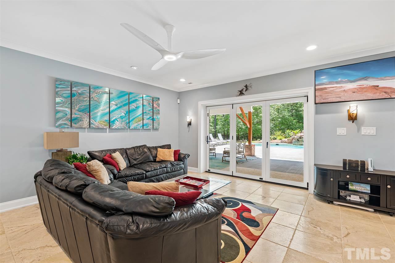 1209 Graedon Drive Raleigh, NC 27603 - Photo 24 of 30 Bring the outside in! Folding glass wall doors to saltwater pool and plethora of outdoor activities from the outdoor kitchen/tiki bar, cabana to horsehoes, bocci court.