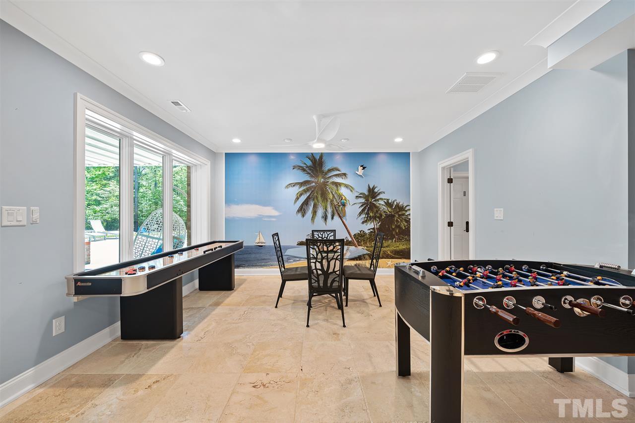 1209 Graedon Drive Raleigh, NC 27603 - Photo 25 of 30 Currently used as a game room-use as flex space of your choice. Spectacular views of pond and pool. Tropical photo mural.
