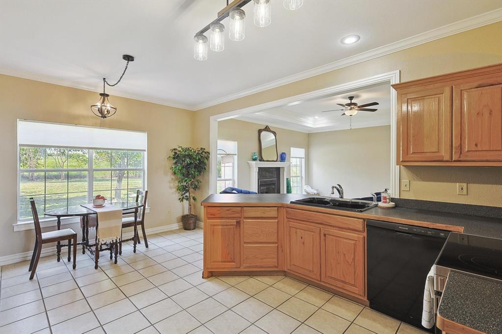 3289 Mitchell Road Krum, TX 76249 - Photo 11 of 40 a kitchen with a sink and chairs
