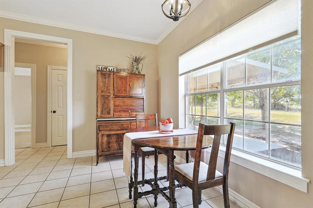 3289 Mitchell Road Krum, TX 76249 - Photo 13 of 40 a dining room with furniture and window